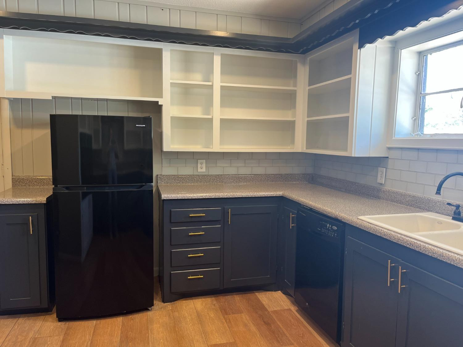 3411 42nd Street Lubbock, TX 79413 - Photo 7 of 33 a kitchen with a refrigerator and a sink