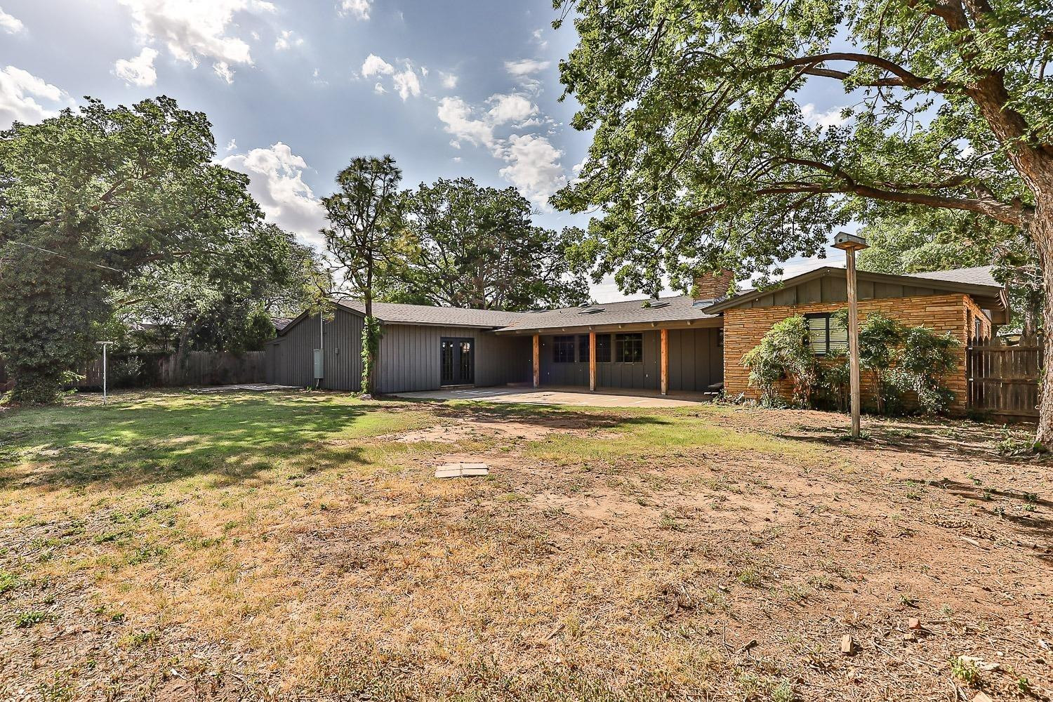 3411 42nd Street Lubbock, TX 79413 - Photo 10 of 33 a backyard of a house with lots of green space