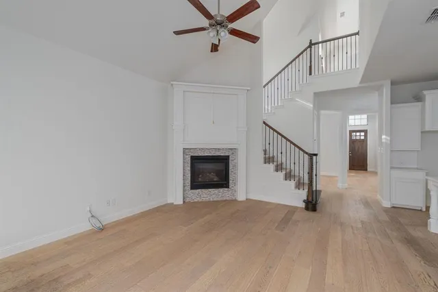 a view of a hallway with wooden floor and entryway
