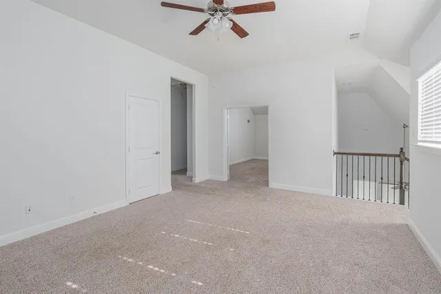 a view of a room with a ceiling fan