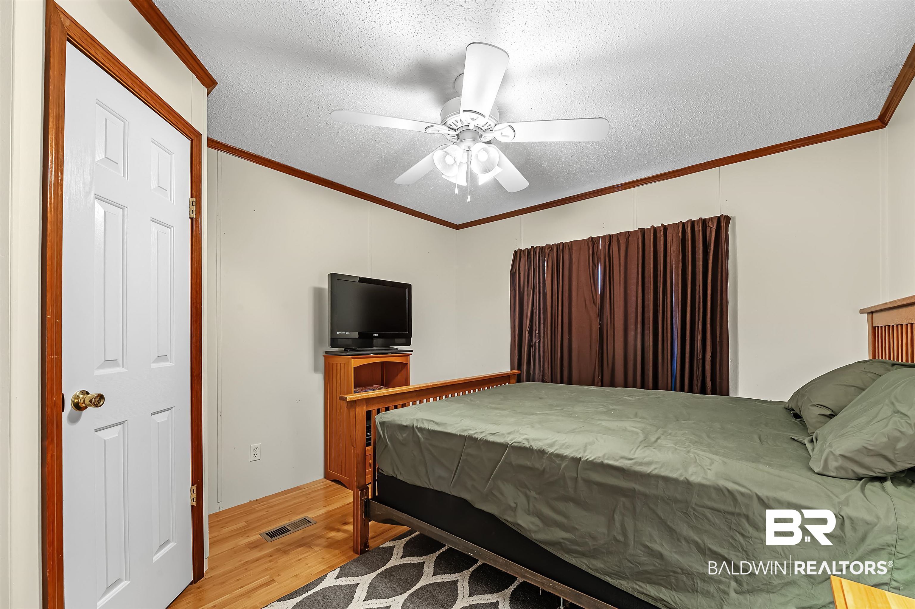 10970 Stucki Road Elberta, AL 36530 - Photo 35 of 56 Bedroom with ornamental molding, a textured ceiling, ceiling fan, and Bamboo floors