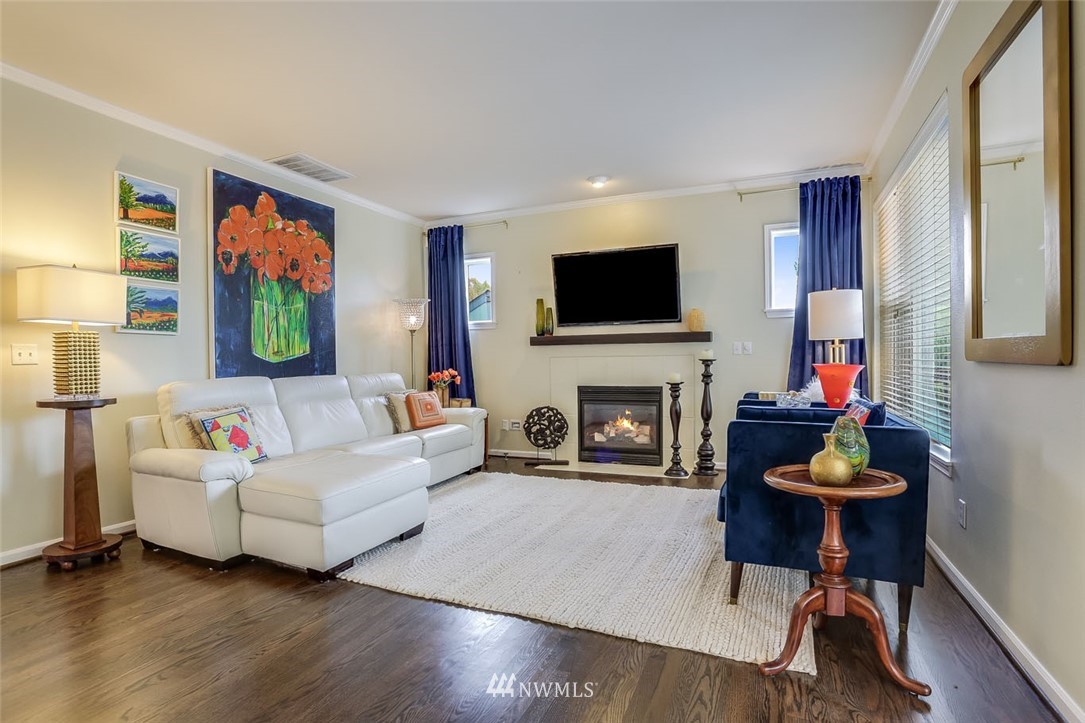 906 North 33rd Street Renton, WA 98056 - Photo 11 of 40 a living room with furniture a fireplace and a flat screen tv