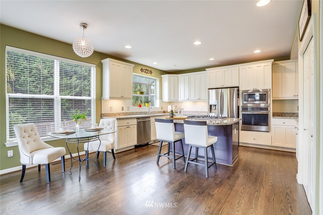 906 North 33rd Street Renton, WA 98056 - Photo 13 of 40 a view of a dining room with furniture window and wooden floor