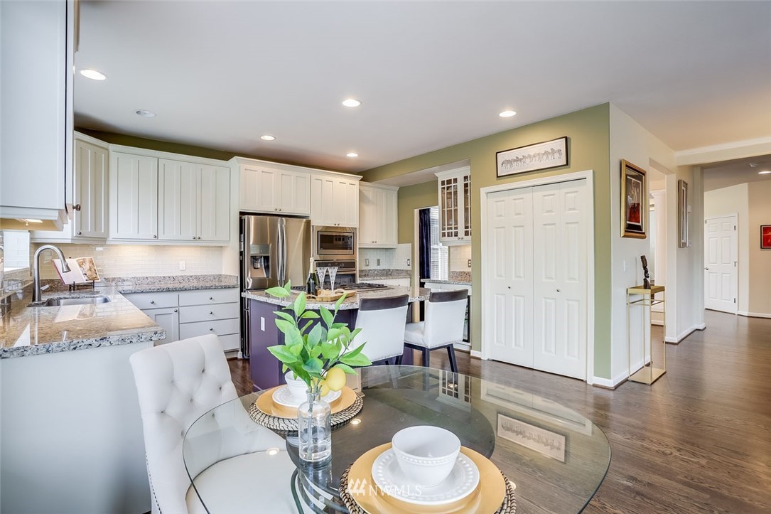 906 North 33rd Street Renton, WA 98056 - Photo 14 of 40 a kitchen with a refrigerator and a stove top oven