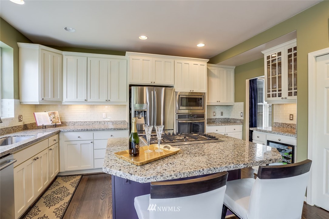 906 North 33rd Street Renton, WA 98056 - Photo 15 of 40 a kitchen with kitchen island granite countertop a table and chairs in it