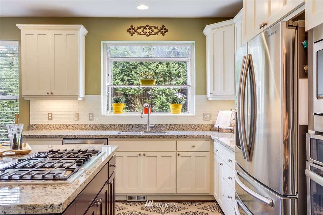 906 North 33rd Street Renton, WA 98056 - Photo 16 of 40 a kitchen with stainless steel appliances granite countertop a refrigerator and a sink