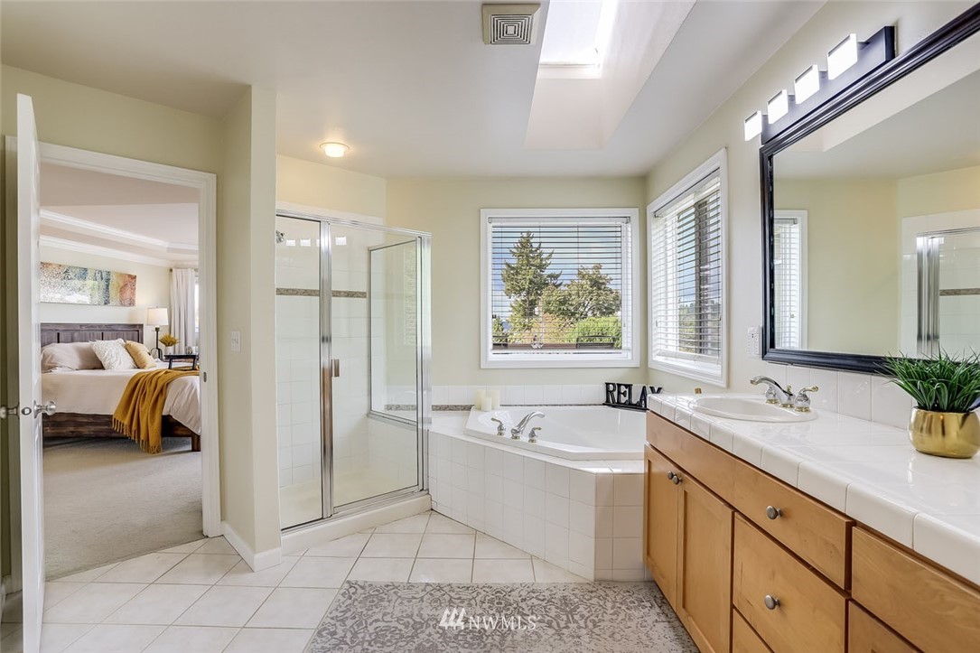 906 North 33rd Street Renton, WA 98056 - Photo 26 of 40 a spacious bathroom with a tub sink and mirror