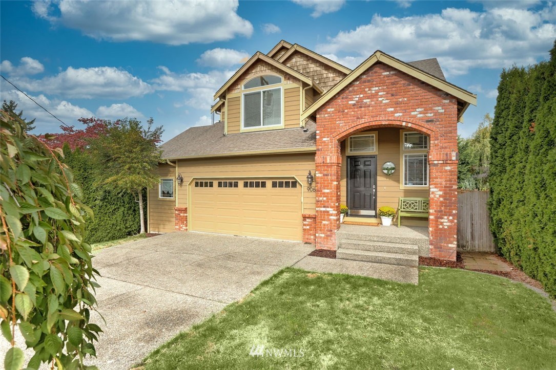 906 North 33rd Street Renton, WA 98056 - Photo 4 of 40 a front view of a house with a yard and garage