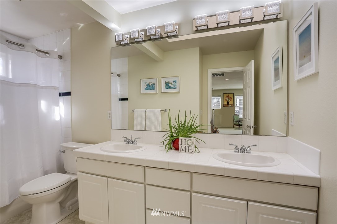 906 North 33rd Street Renton, WA 98056 - Photo 32 of 40 a bathroom with a sink toilet and a mirror