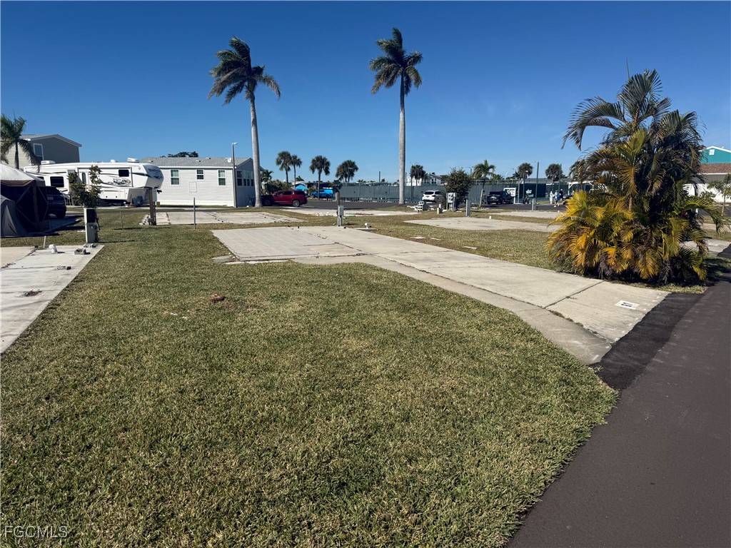19681 Summerlin Road, Unit 87 Fort Myers, FL 33908 - Photo 2 of 15 a view of a yard with cars