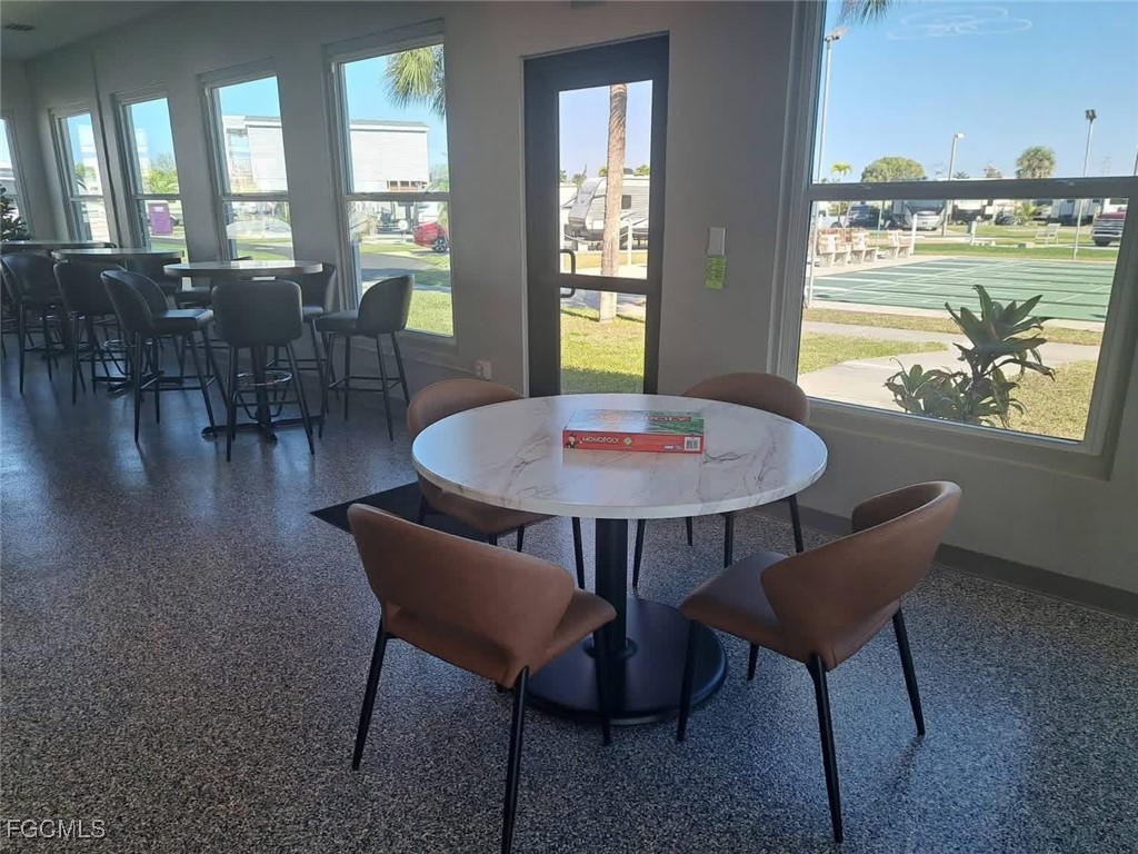 19681 Summerlin Road, Unit 87 Fort Myers, FL 33908 - Photo 7 of 15 a view of a dining room with furniture window and wooden floor