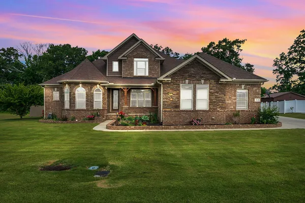 a front view of a house with a yard
