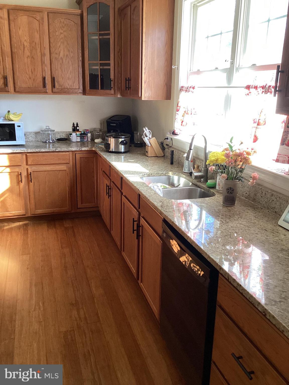 7612 Marye Road Spotsylvania, VA 22551 - Photo 5 of 39 a kitchen with stainless steel appliances granite countertop wooden cabinets a sink and dishwasher with wooden floor