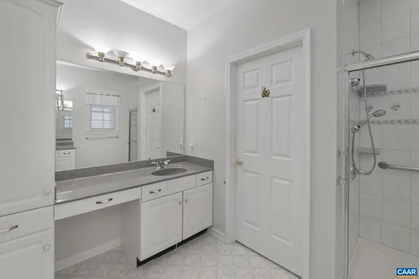 a view of a lake with a yard and large trees