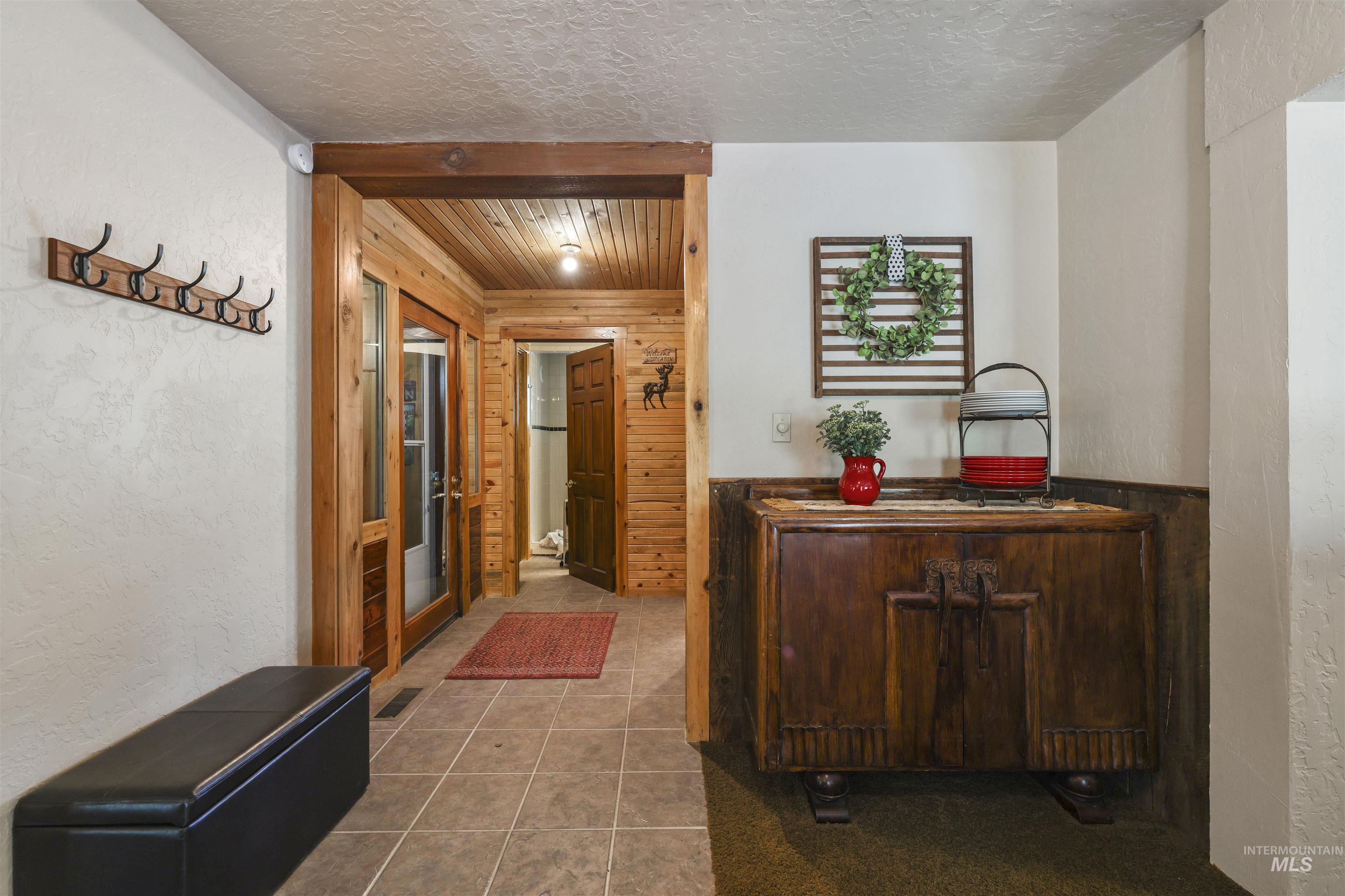 224 Dakota Road Mountain Home, ID 83647 - Photo 4 of 50 Entryway featuring wood-finish paneling and trim, a recessed ceiling light, and tile flooring