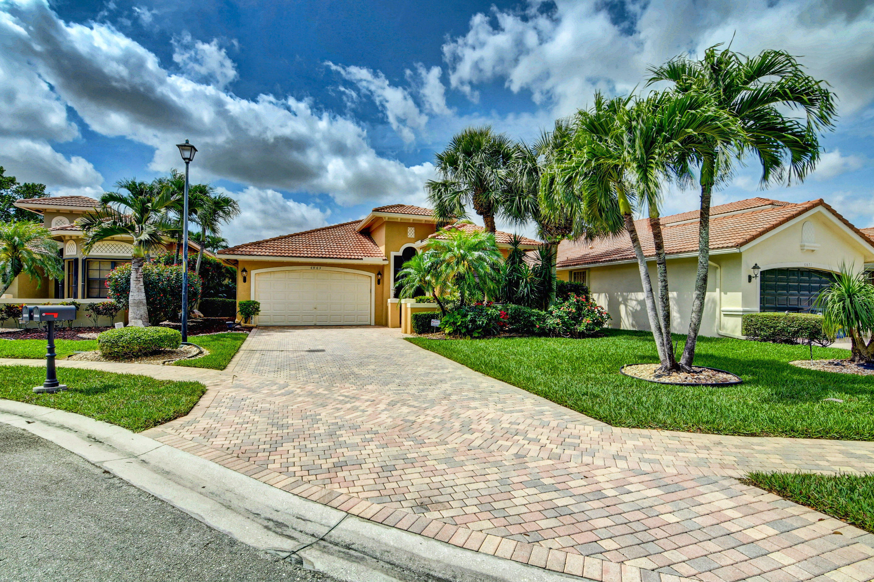 6863 Boscanni Drive Boynton Beach, FL 33437 - Photo 2 of 61 a front view of a house with garden