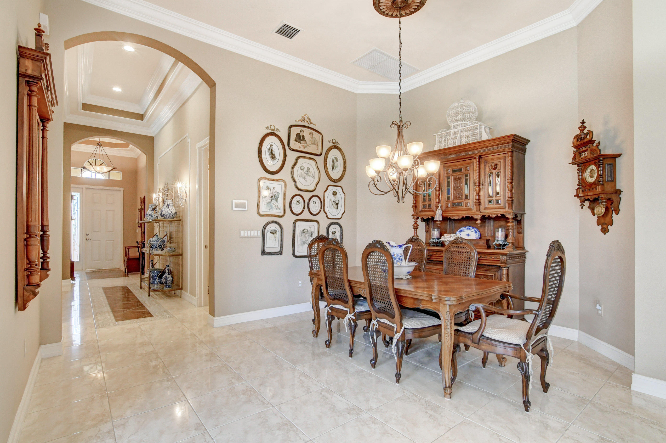 6863 Boscanni Drive Boynton Beach, FL 33437 - Photo 13 of 61 a view of a dining room and livingroom with furniture wooden floor a chandelier