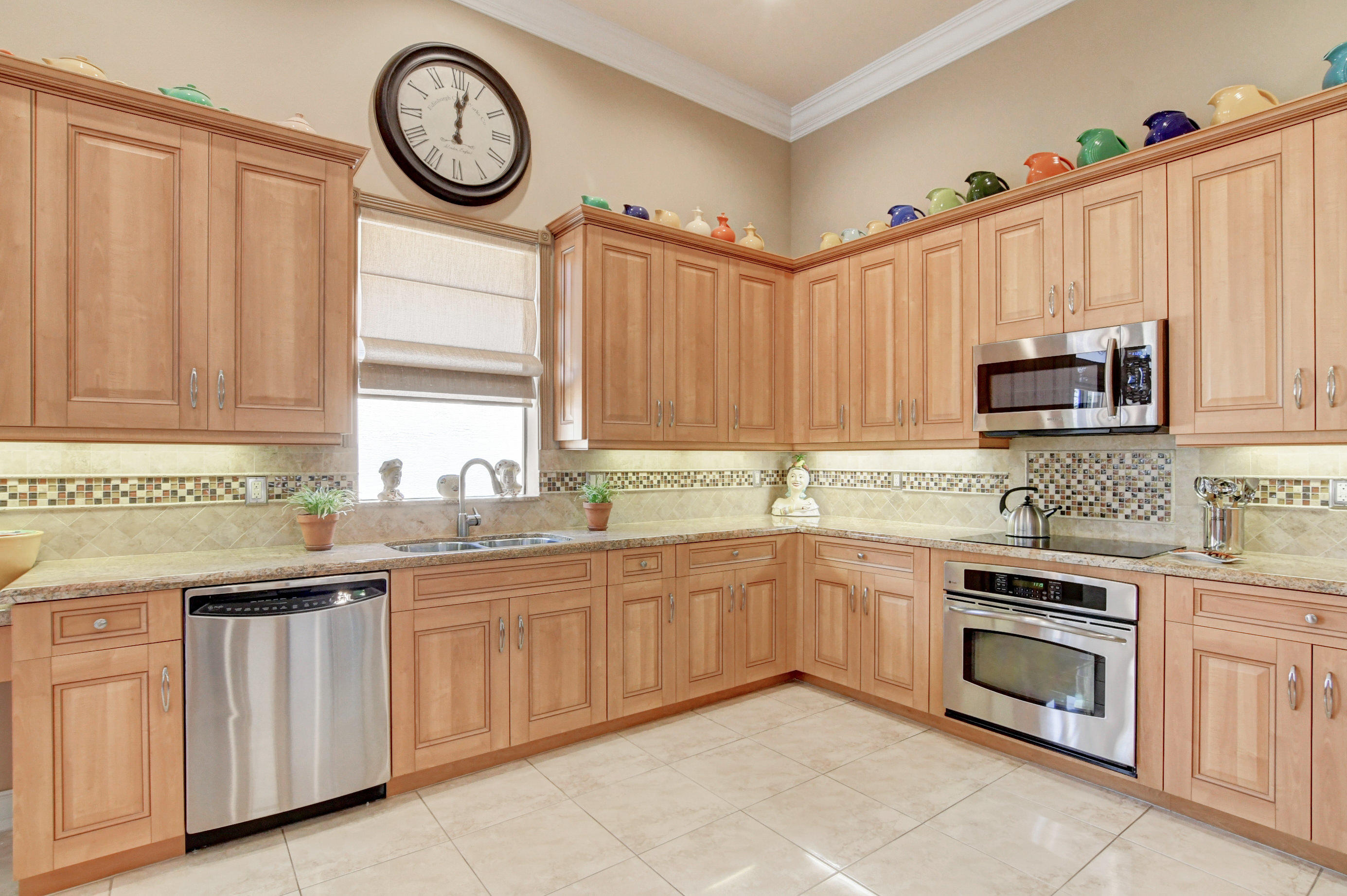 6863 Boscanni Drive Boynton Beach, FL 33437 - Photo 22 of 61 a kitchen with appliances cabinets a sink and a window