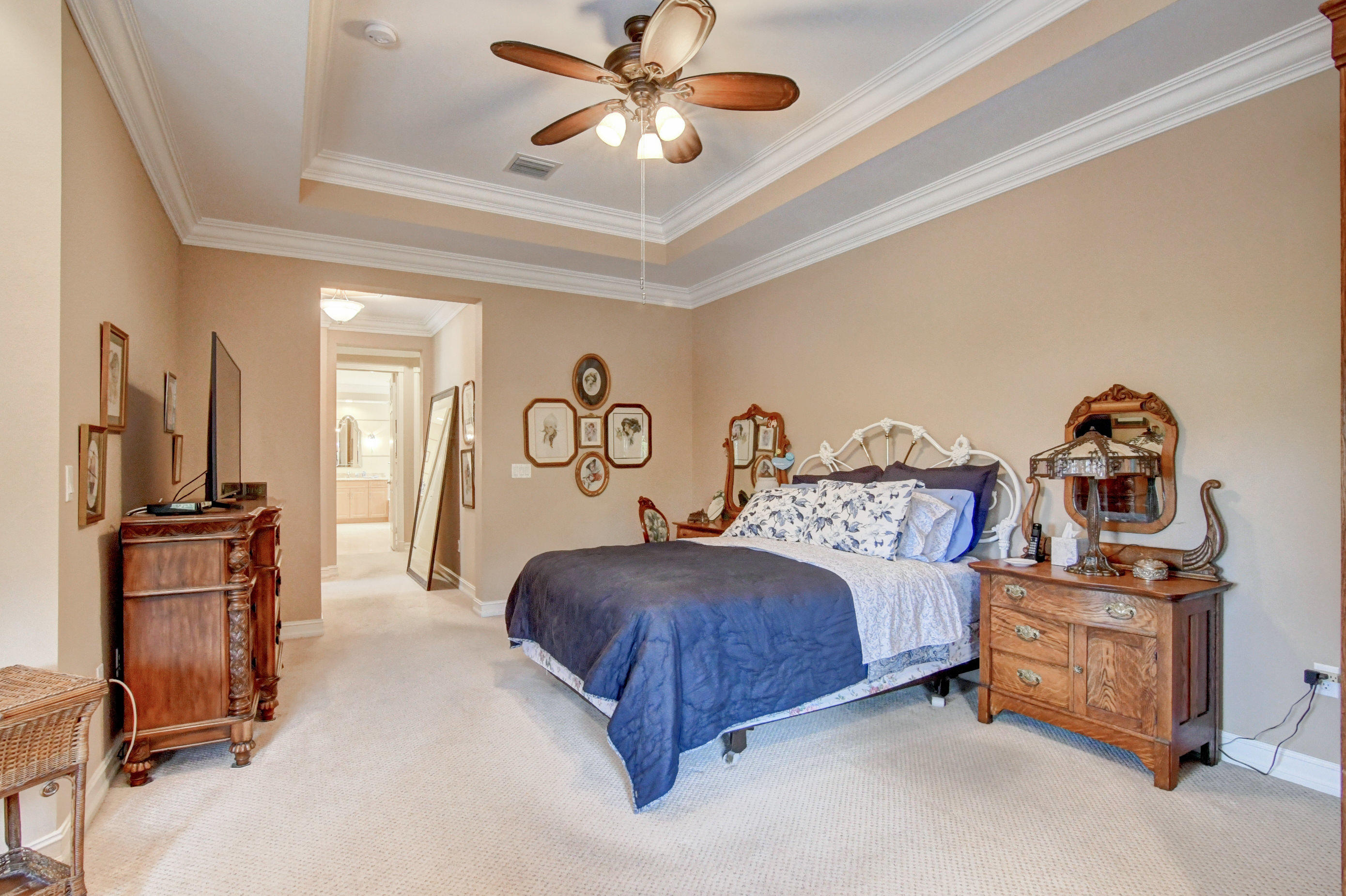6863 Boscanni Drive Boynton Beach, FL 33437 - Photo 26 of 61 a spacious bedroom with a bed and a chandelier