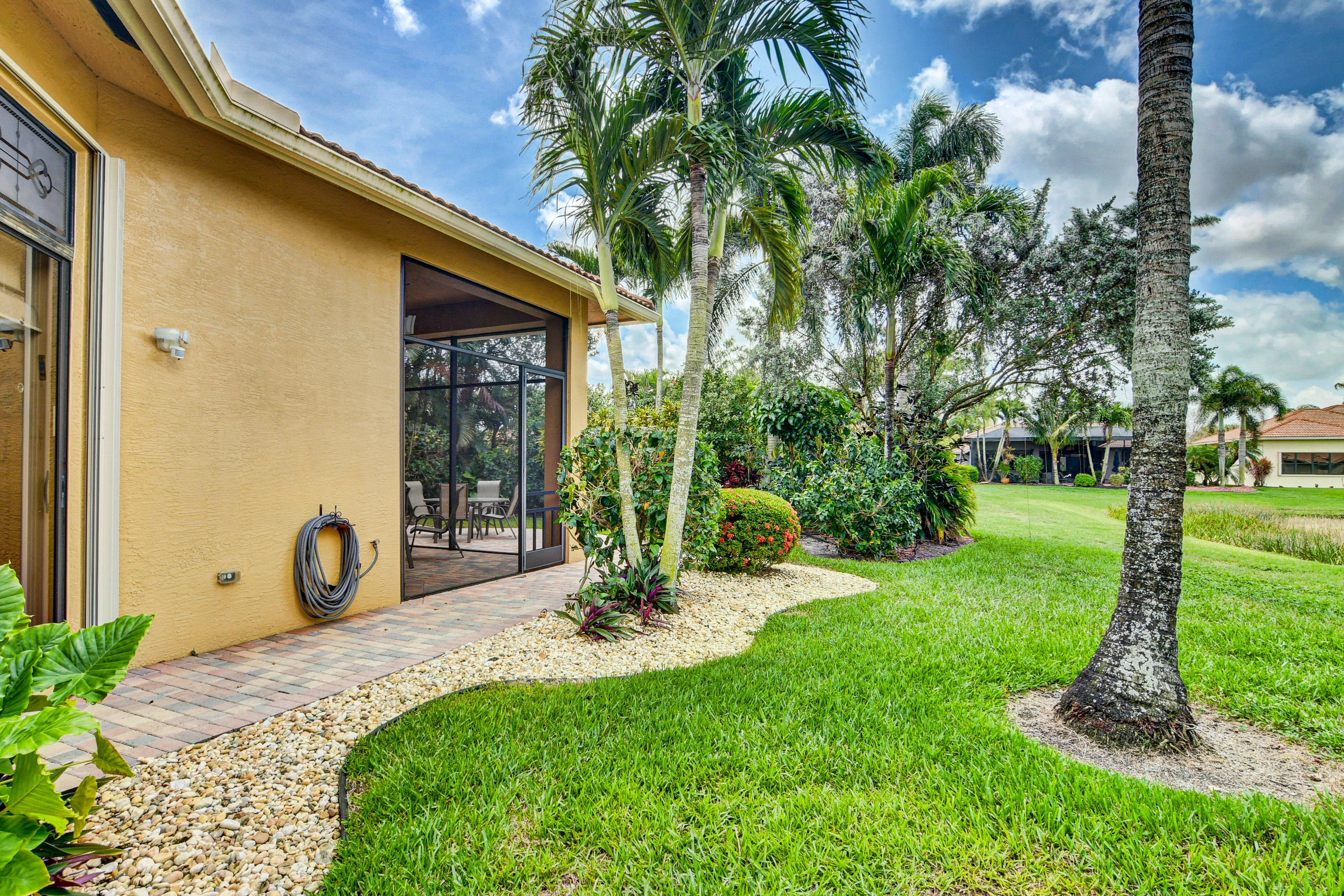 6863 Boscanni Drive Boynton Beach, FL 33437 - Photo 35 of 61 a front view of a house with garden