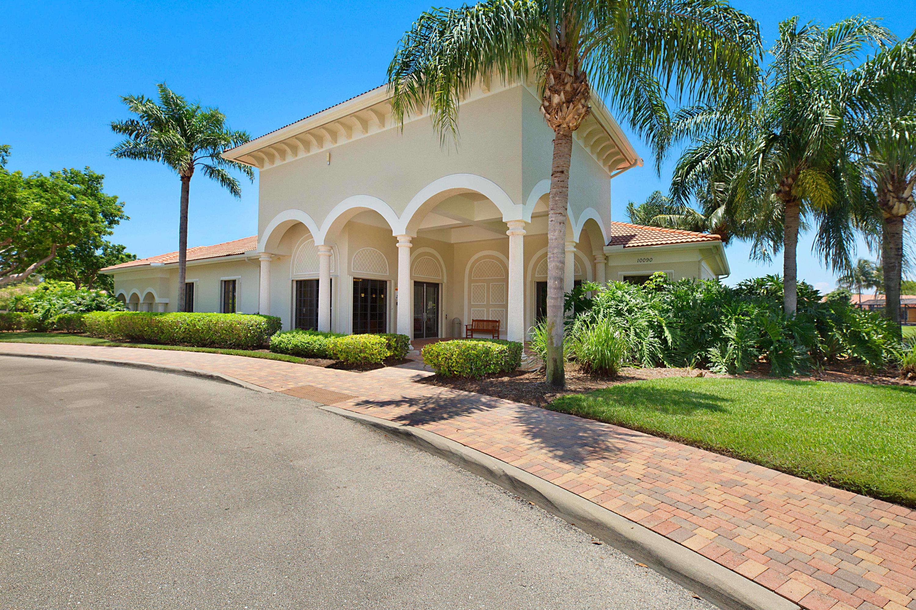 6863 Boscanni Drive Boynton Beach, FL 33437 - Photo 59 of 61 a front view of a house with a garden