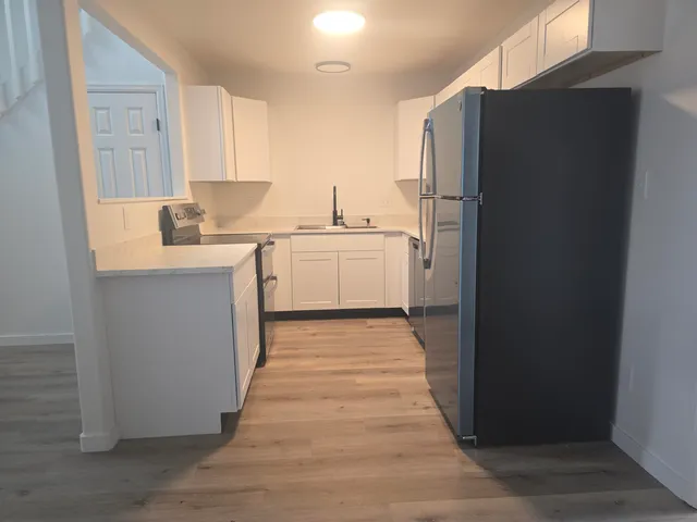 a kitchen with a refrigerator and a sink