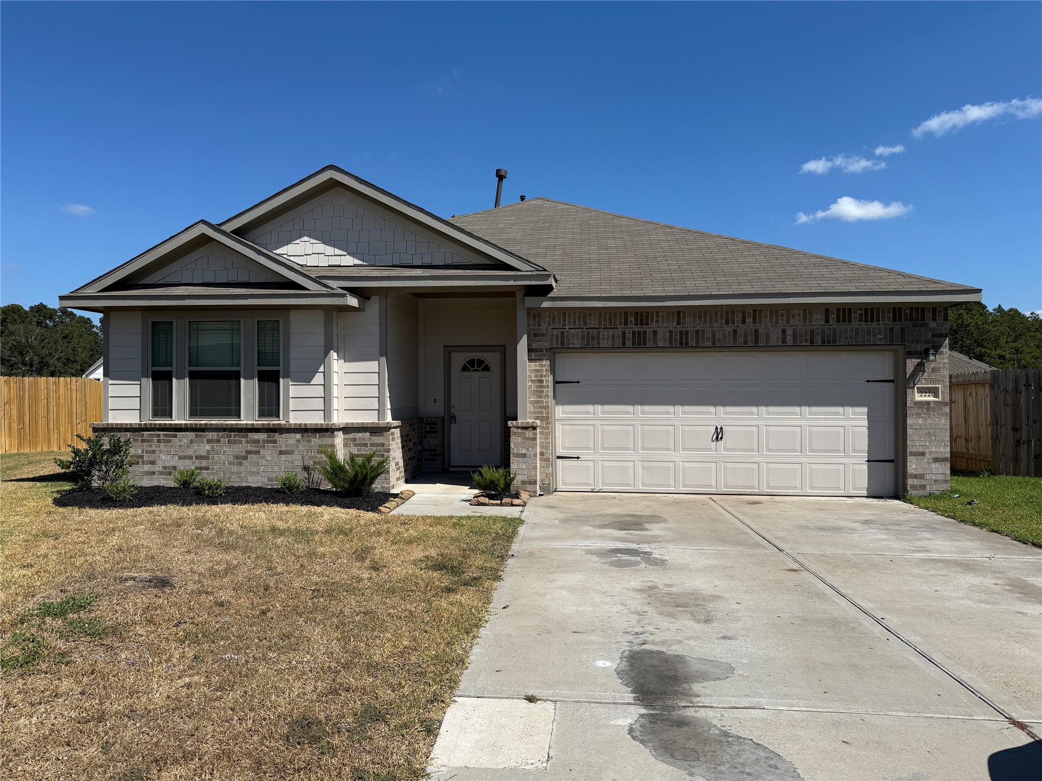 2220 Cedar Valley Drive Conroe, TX 77306 - Photo 1 of 22 a front view of a house with a yard