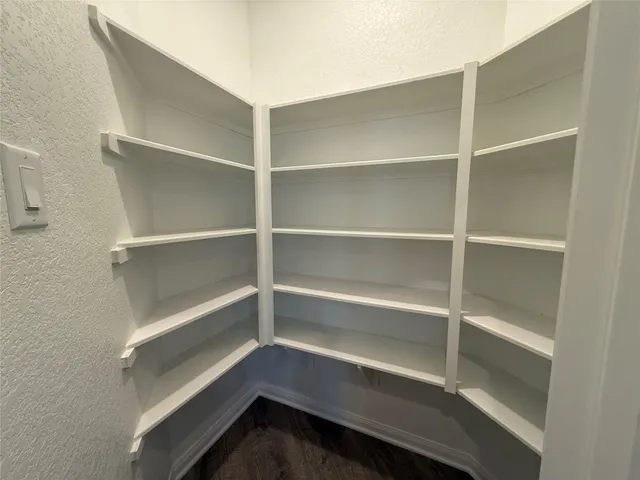 a view of walk in closet with empty racks