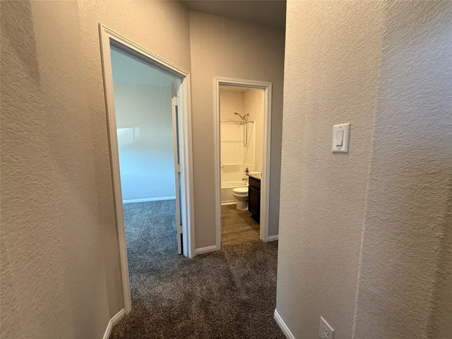 a view of a bathroom from the hallway