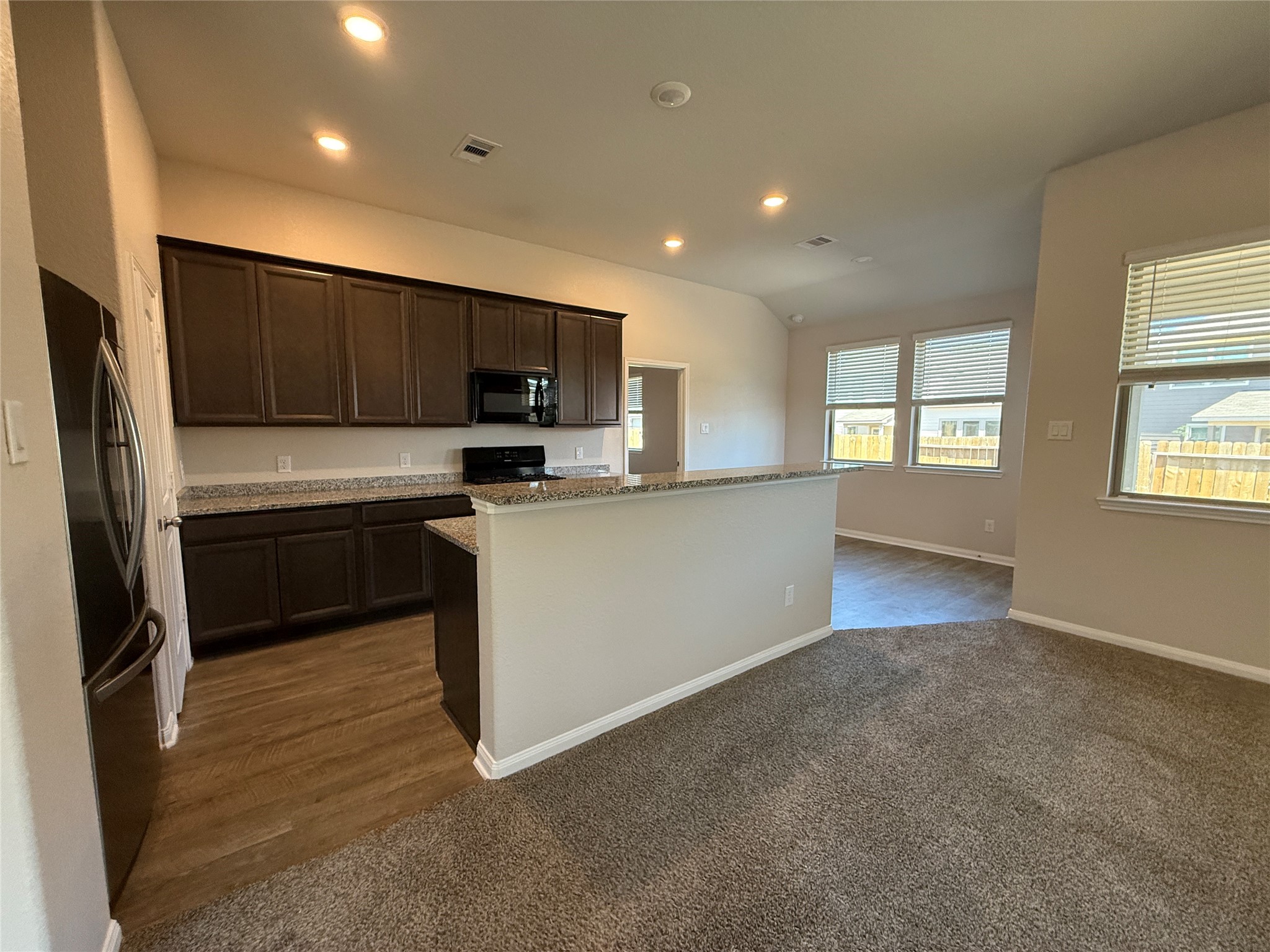 2220 Cedar Valley Drive Conroe, TX 77306 - Photo 10 of 22 a kitchen with kitchen island a sink stainless steel appliances and cabinets