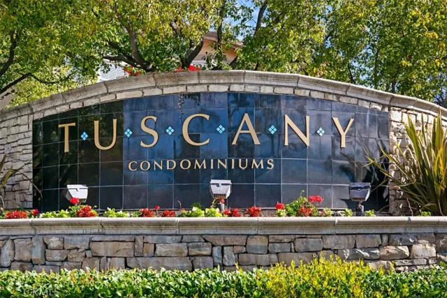 an empty room with wooden floor fireplace and windows