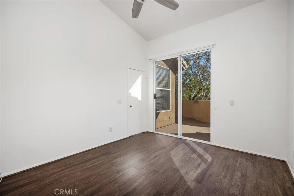 19431 Rue De Valore Lake Forest, CA 92610 - Photo 20 of 30 an empty room with wooden floor and windows
