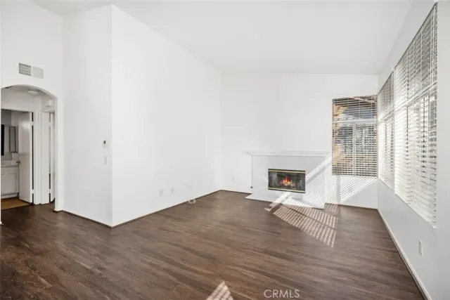 a kitchen with granite countertop a sink a stove and cabinets