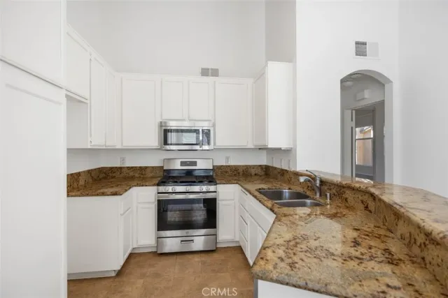 a view of a kitchen with wooden floor and a kitchen