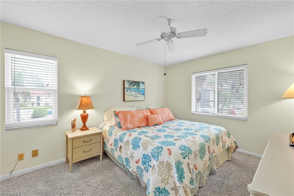 4287 27th Court Southwest, Unit 202 Naples, FL 34116 - Photo 11 of 17 a bedroom with a bed and a window