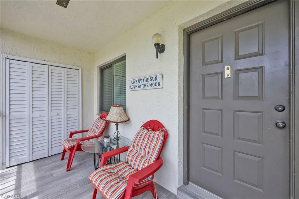 4287 27th Court Southwest, Unit 202 Naples, FL 34116 - Photo 8 of 17 a view of a room with furniture and wooden floor