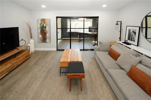a living room with furniture and a flat screen tv