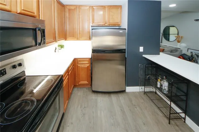 a kitchen with a sink appliances and cabinets