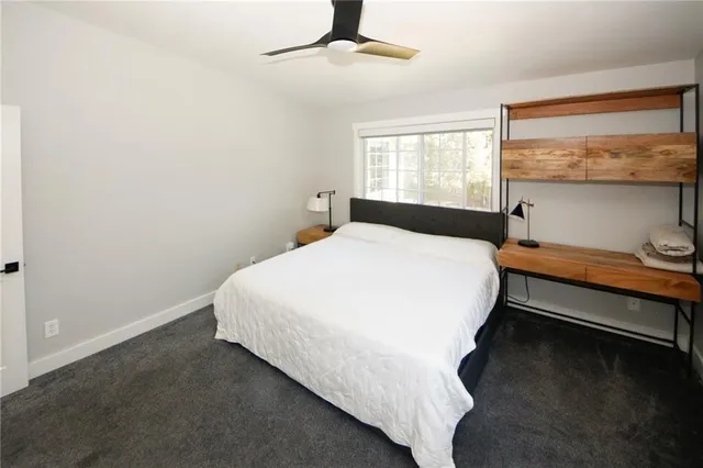 a bedroom with a bed and window