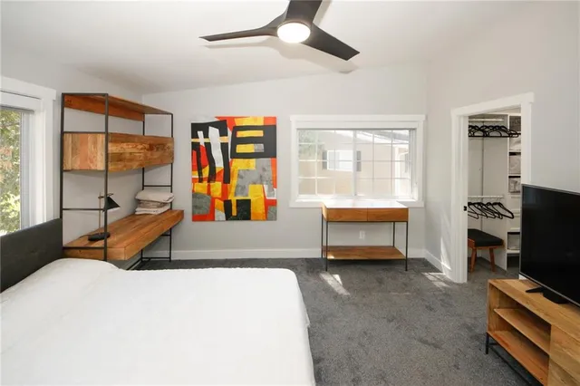 a bedroom with furniture and a flat screen tv