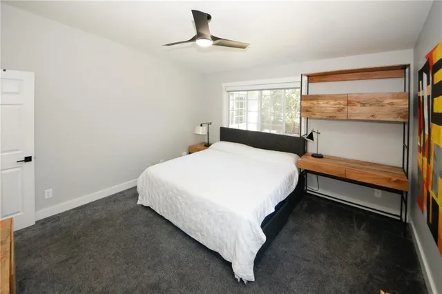 a bedroom with a bed and window