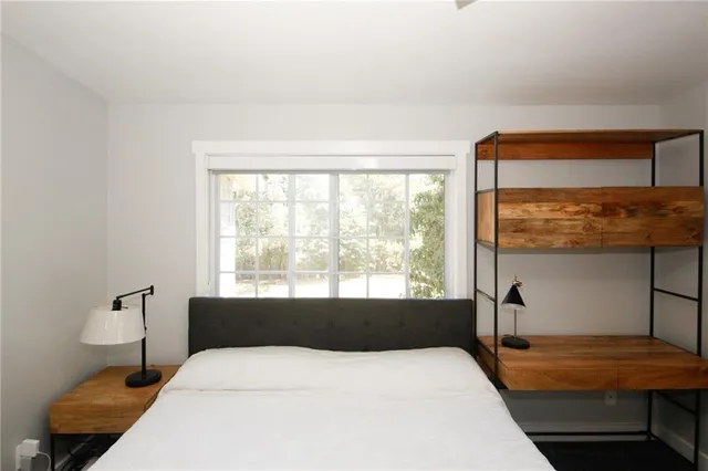 a bedroom with a bed and a window