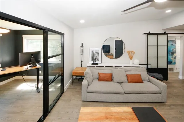 a living room with furniture and a mirror