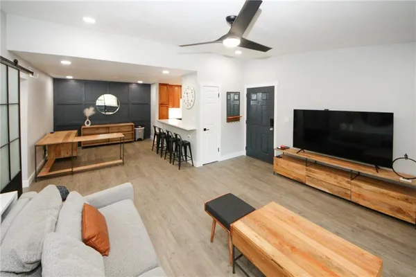 a living room with furniture and a flat screen tv