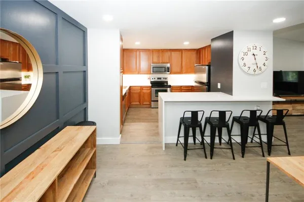 a living room with stainless steel appliances kitchen island granite countertop furniture and a view of kitchen