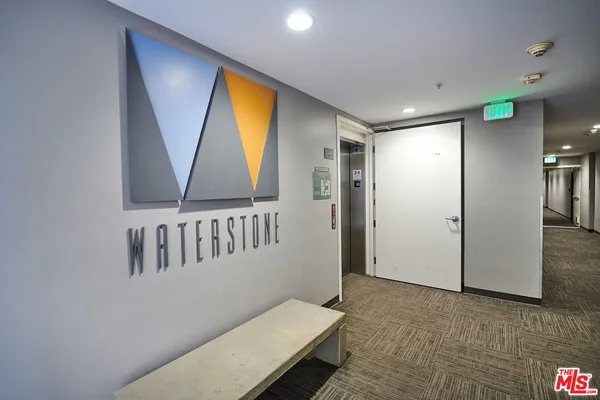 a city street lined with tall buildings and cars parked in front of it