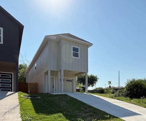 6702 South Lancaster Road Dallas, TX 75241 - Photo 1 of 20 Elevated architecture with panel siding, an integrated garage, a private entry, and an extended concrete driveway