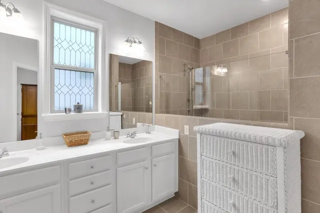 a spacious bathroom with a double vanity sink mirror and double