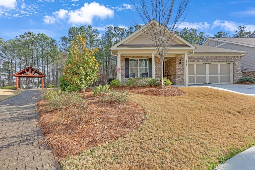 1598 Auburn Rdg Way Dacula, GA 30019 - Photo 2 of 34 a front view of a house with a yard and trees