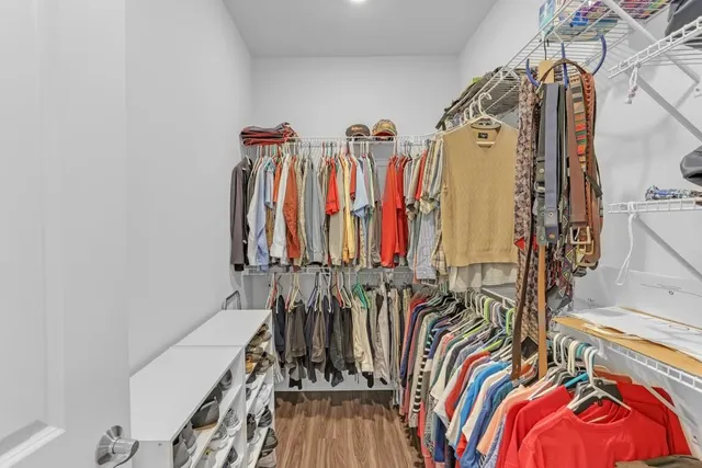 a view of walk in closet with clothes